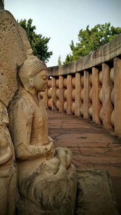 an ancient statue sits in the middle of a walkway