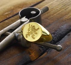 Elegant Solid Gold Heraldic Lion Signet Ring - Handcrafted Wax Seal Design Is there a different crest you would like? Please contact us for a price quote.  Overview: - Item Type: Handmade Signet Ring - Material: Premium Solid 10k, 14k, or 18k Gold - Featuring: Carved Heraldic Lion - Style: Wax Seal - Gender-neutral Design - Customizable Size and Fit - Crafted on Demand Product Description: Introducing our regal solid gold signet ring, adorned with a meticulously carved heraldic lion, a symbol of courage, nobility, and strength. This ring, inspired by the grandeur of heraldic emblems, embodies a blend of historical significance and contemporary style. Symbolism: The heraldic lion is a timeless symbol, often associated with royalty and heraldry. It represents bravery, valor, and leadership, Gift Ring With Maker's Mark, Luxury Anniversary Signet Ring With Maker's Mark, Luxury Anniversary Rings With Maker's Mark, Yellow Gold Jewelry With Maker's Mark As Gift, Gift Yellow Gold Jewelry With Maker's Mark, Luxury Jewelry With Maker's Mark For Anniversary, Custom Oval Hallmarked Signet Ring, Heraldic Lion, Gold Wax Seal