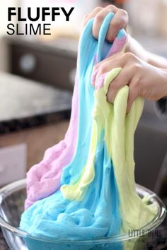 someone is using colored slime to make something blue and green with the words fluffy slime on it