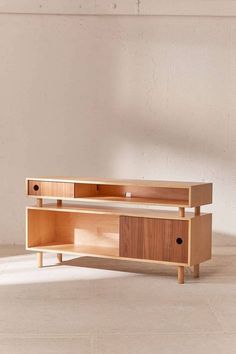 a wooden entertainment center with two drawers on one side and an open drawer on the other