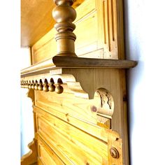 a wooden dresser with drawers and knobs on it