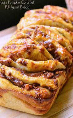 an easy pumpkin caramel pull apart bread on a cutting board with text overlay