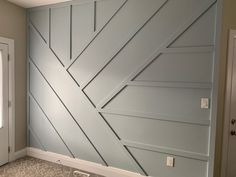 an empty room with blue painted walls and white trim on the wall, along with two doors