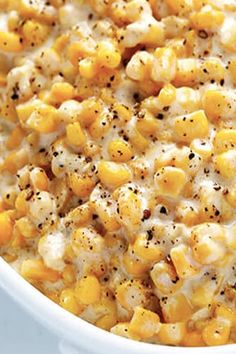 a white bowl filled with corn and cheese