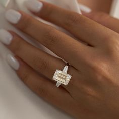 a woman's hand with a diamond ring on it