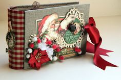 a christmas card album with santa claus and poinsettis