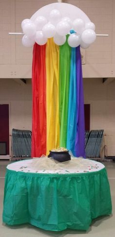 a table topped with balloons and a cake