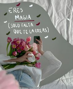 a woman taking a selfie in front of a mirror with flowers on her head