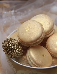 a white bowl filled with macaroons on top of a table