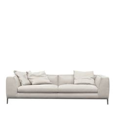 a white couch with lots of pillows on it's back and arms, against a white background