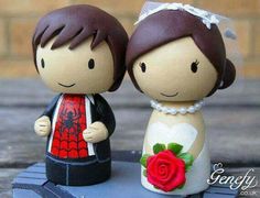 a wedding cake topper with a bride and groom figurine next to each other