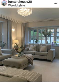 a living room filled with furniture and a chandelier