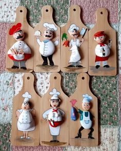 six wooden cutting boards with cartoon chefs on them, each holding a pepper shaker