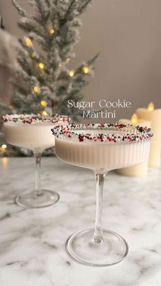 two desserts sitting on top of a table next to a christmas tree