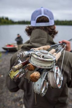 a person holding fishing gear near the water