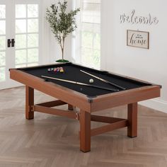 a pool table with cues and balls on it