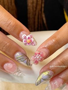 a woman's nails with flowers on them