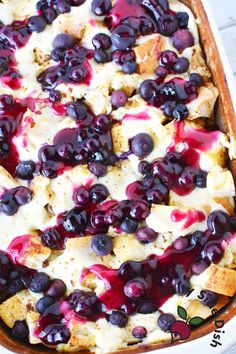 a casserole dish with blueberries and cream cheese