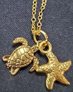 20 inch gold plated chain with gold turtle and sea star charms Gold Charm Necklace With Star Charm For Beach, Gold Charm Necklace With Star For Beach, Gold Star Charm Necklace For Beach, Gold Metal Jewelry With Starfish Charm, Gold Jewelry With Starfish Charm, Gold Ocean-inspired Charm Necklaces As Gift, Gold Ocean-inspired Charm Necklace For Gift, Ocean-inspired Gold Charm Necklace For Gift, Starfish Charm Metal Necklace For Gift