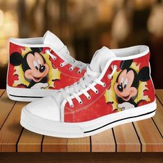 Classic Minnie Mouse Disney Cartoon High Top Shoes Sporty Top Sneakers High-top canvas shoes exude a unique blend of casual comfort and trendy fashion. These iconic shoes feature a high-rise design that wraps the ankle, providing exceptional support and style. Crafted from breathable and lightweight canvas material, they offer comfort and flexibility for everyday wear. Their versatile nature effortlessly transitions from laid-back outings to trendy urban styles, allowing for easy pairing with va Mickey Shoes, Cartoon High, Black High Top Shoes, Top Shoes For Men, Disney High, Disney Print, Comfortable Walking Shoes, Disney Shoes, White High Tops