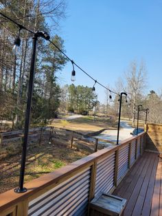 a wooden deck with benches and lights on it