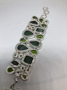 Vintage green gemstone bracelet Hand set in low content silver NOT 925 Bloodstone, Chrysoprase and antique peridot glass About 2 in wide Adjusts 6-8 in All jewelry is shipped in a nice gift box. Check out our over a THOUSAND great reviews Engraving is $4 per letter and is not always perfect depending on the piece. It can take a few days if the jeweler is busy. This is payable to Paypal Judithsltd@gmail.com Elegant Green Cabochon Bracelets, Green Bangle Bracelets In Fusion Style, Fusion Green Bangle Bracelets, Green Bohemian Bracelets With Stones, Green Fusion Bangle Bracelet, Green Fusion Style Bangle Bracelets, Green Nickel-free Collectible Jewelry, Green Metal Collectible Jewelry, Green Bangle For Collectible Jewelry