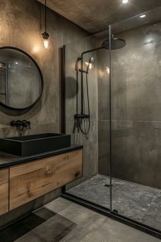 a bathroom with a sink, mirror and shower in it's stall area at night