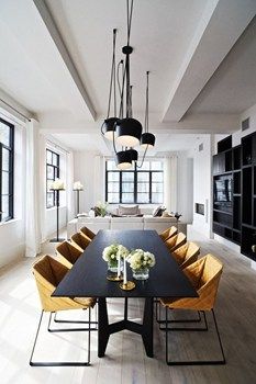 a dining room table with yellow chairs around it