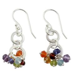 Colorful gems dangle from interlocking loops in earrings from Ritu's chakra jewelry collection. Crafted by hand the sterling silver earrings feature amethyst blue topaz iolite citrine carnelian garnet and peridot. Each gem is associated with a chakra on the basis of its color. The clear and light purple stones are associated with the 7th chakra (awareness and wisdom); the purple violet and indigo gems with 6th chakra (insight and perception) and the blue or light blue with the 5th that of commun Chakra Earrings, Chakra Jewelry, Purple Stones, National Geographic, Gemstone Earrings, Pandora Charm Bracelet, Blue Topaz, Fashion Earrings, Citrine