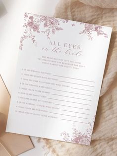 an all eyes on the bride game is shown next to a gold envelope and pink flowers