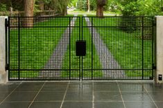 an open gate leading into a lush green park