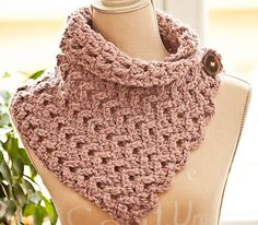 a pink crocheted cowl on top of a mannequin