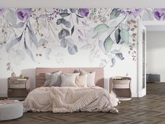 a bedroom decorated in pastel tones with flowers painted on the wall and bedding