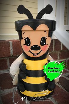 a bee planter sitting on top of a brick walkway