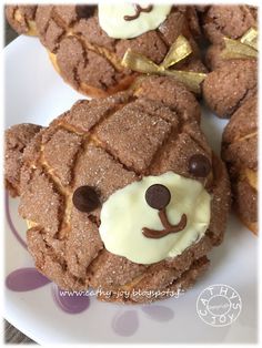 some cookies with icing on them are shaped like a bear