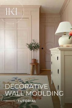 a white dresser sitting next to a pink wall