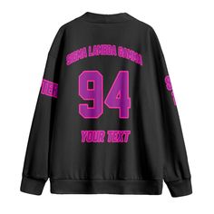 a black sweatshirt with pink letters on the sleeves and numbers printed on the back, in front of a white background