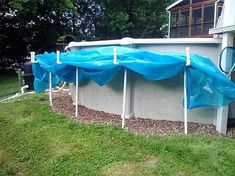 an above ground pool covered in blue tarps