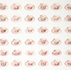 tea cups and saucers are arranged on a white background