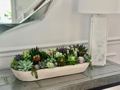 a planter filled with succulents on top of a table