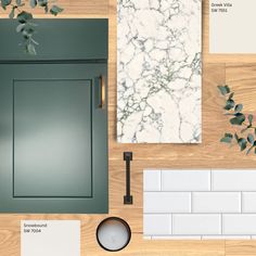 the top view of a kitchen counter with green cabinets and white tiles on it, along with other accessories