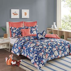 a bed with blue and red comforters in a room