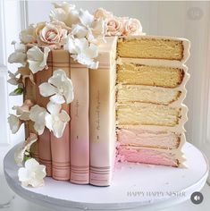 the cake is decorated with flowers and books