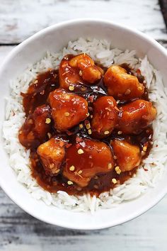 a white bowl filled with rice covered in sauce