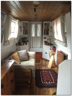 a living room filled with furniture and lots of wood paneling on the walls,