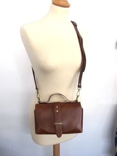 Handmade shoulder leather bag with a classy shape. It can be worn cross-body too and despite its small shape can easily hold your daily essentials. Also, it's a perfect choice for a night out, just remove the shoulder strap and carry it with the featuring top handle. It comes without lining in 6 colors brown, black, goldish black, bordeaux, light gray and ivory. The hardware is available in silver, gold and bronze. WIDTH: 20cm/7.9 inches, LENGTH: 12cm/4.7inches DEPTH: 8cm/3.1inches ADJUSTABLE ST Classic Leather Crossbody Backpack With Detachable Strap, Classic Leather Crossbody Backpack With Removable Pouch, Everyday Crossbody Flap Bag, Everyday Use Soft Leather Crossbody Flap Bag, Soft Leather Crossbody Flap Bag For Everyday Use, Leather Crossbody Backpack For Office, Classic Leather Crossbody Backpack For On-the-go, Leather Flap Clutch Bag, Classic Crossbody Shoulder Bag For Everyday