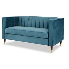 a blue velvet couch with gold legs