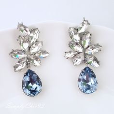 "Elegant Vintage style Bridal Earrings. Made with high-quality Crystal rhinestones in light blue and clear crystals. Gorgeous and elegant floral-inspired drops. Pair them with a cocktail dress or an over-sized sweater for an everyday look. Rhodium silver plated 2\" length, 1\" width Glass crystals Surgical steel posts, hypoallergenic" Goth Corsets, Crystals Labradorite, Earrings Weddings, Swarovski Drop Earrings, Blue Statement Earrings, Royal Blue Earrings, Quinceanera Jewelry, Blue Bridal Earrings, Blue Chandelier