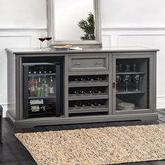 an entertainment center with two wine coolers and a mirror