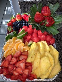 a tray filled with fruits and vegetables on top of a counter